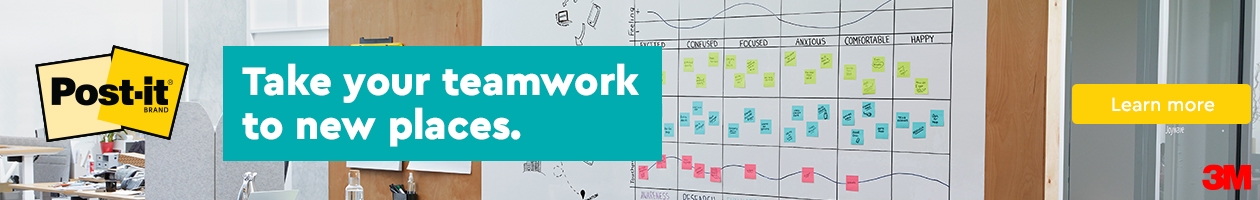 A large open-concept office space with a space for team collaboration. Post-it Flex Write Surface covers an extra large wall where team members are sharing ideas written in marker and different colour Post-it notes stuck to the surface.